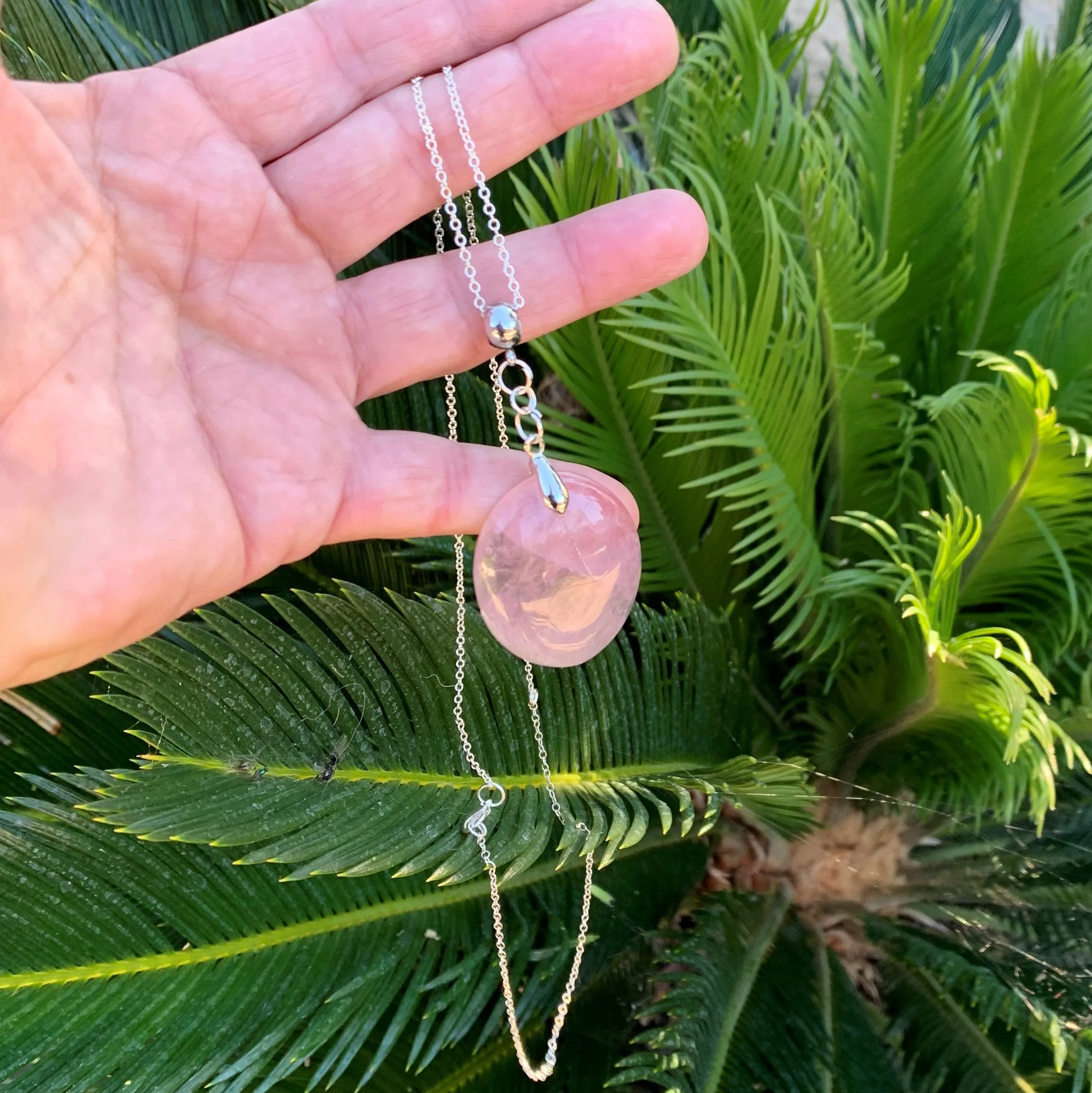 Natural rose quartz pendant with its silver chain