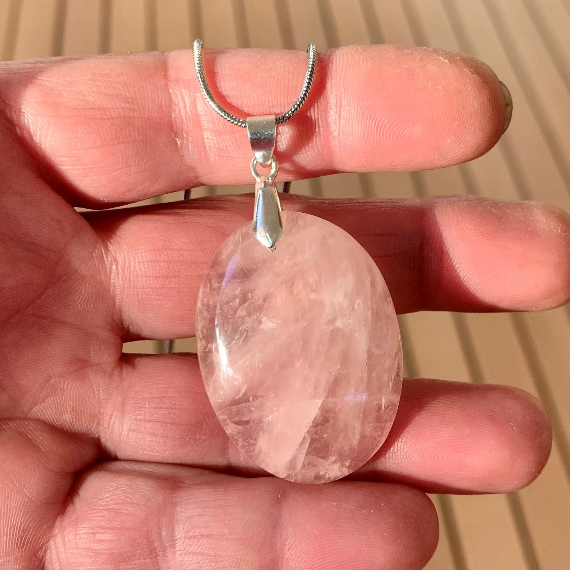 Natural rose quartz pendant with its silver chain